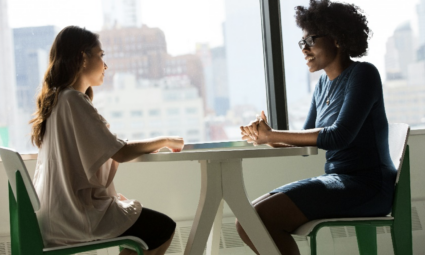 Two women sitting at a table talking